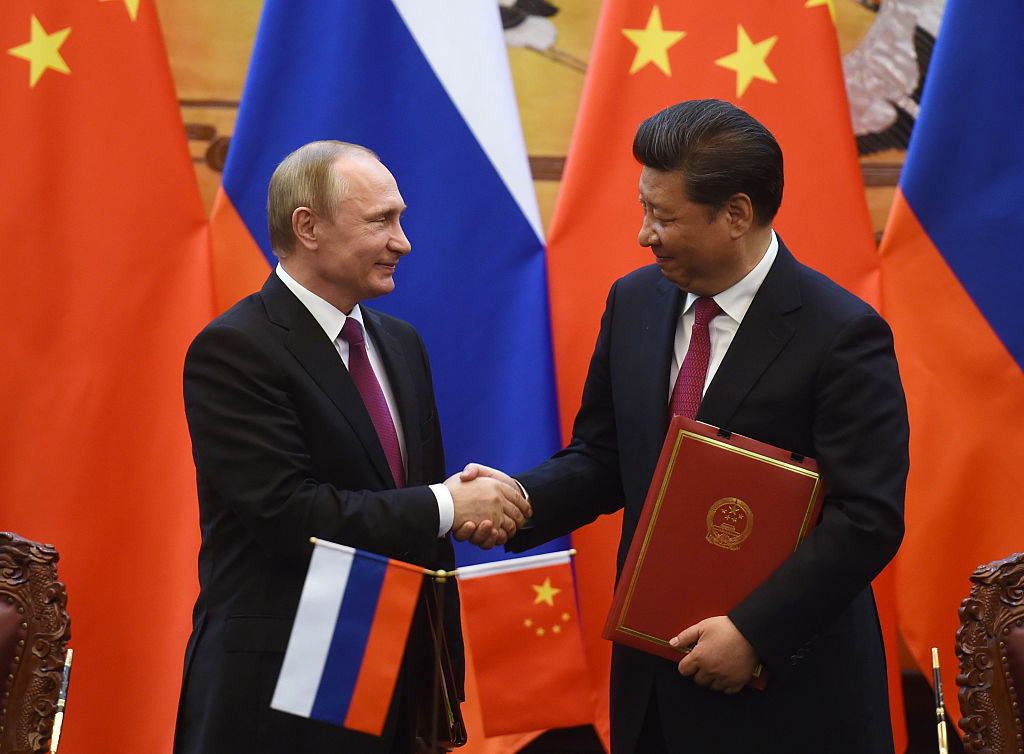 BEIJING, CHINA - JUNE 25: Russian President Vladimir Putin (L) shakes hands with Chinese President Xi Jinping during a signing ceremony in Beijing's Great Hall of the People on June 25, 2016 in Beijing, China. Russian President Vladimir Putin is in China to discuss more economic and military cooperation between the two countries. (Photo by Greg Baker-Pool/Getty Images)