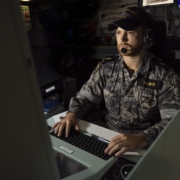 Image of Able Seaman Combat Systems Operator Haimish Kilner monitoring a combat system console aboard HMAS Warramunga: Leo Baumgartner/Department of Defence.