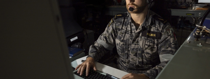 Image of Able Seaman Combat Systems Operator Haimish Kilner monitoring a combat system console aboard HMAS Warramunga: Leo Baumgartner/Department of Defence.