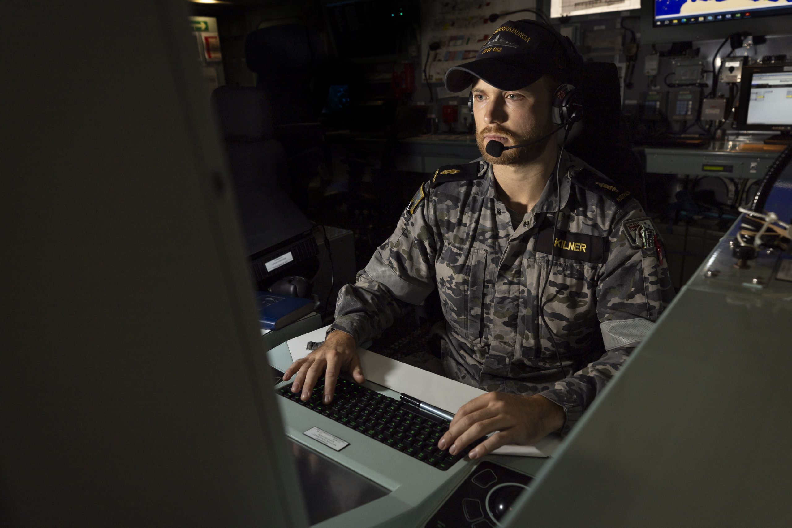 Image of Able Seaman Combat Systems Operator Haimish Kilner monitoring a combat system console aboard HMAS Warramunga: Leo Baumgartner/Department of Defence.